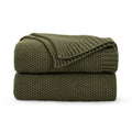 Olive green chunky knit throw blanket, folded with ribbed texture.