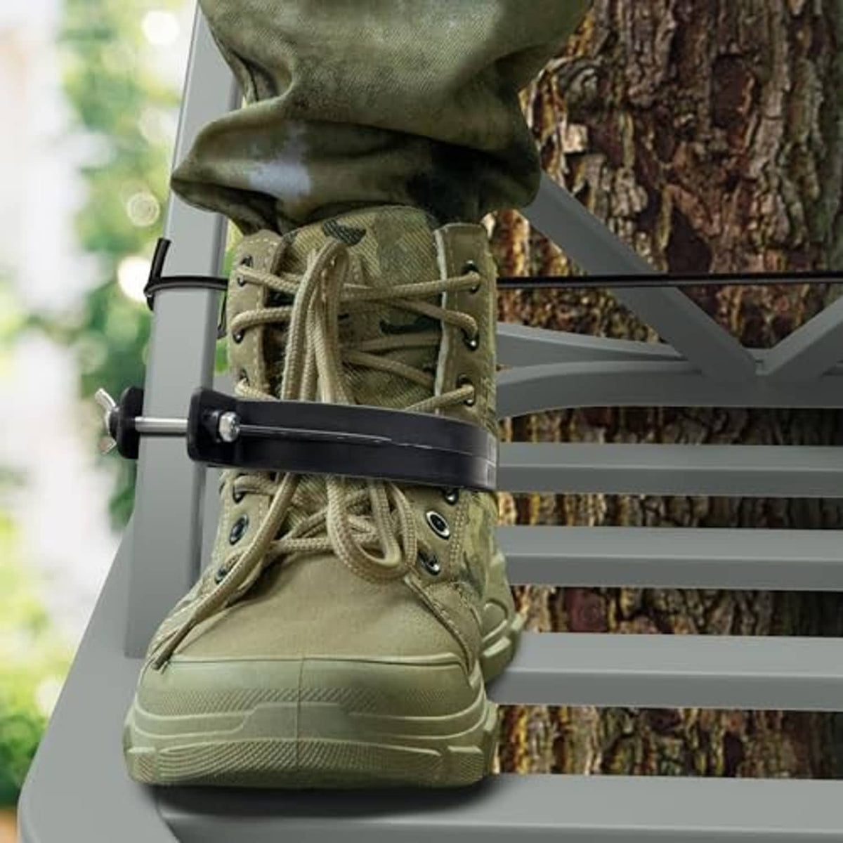 Climbing tree stand stirrup accessory holding olive camo boots with elastic rope