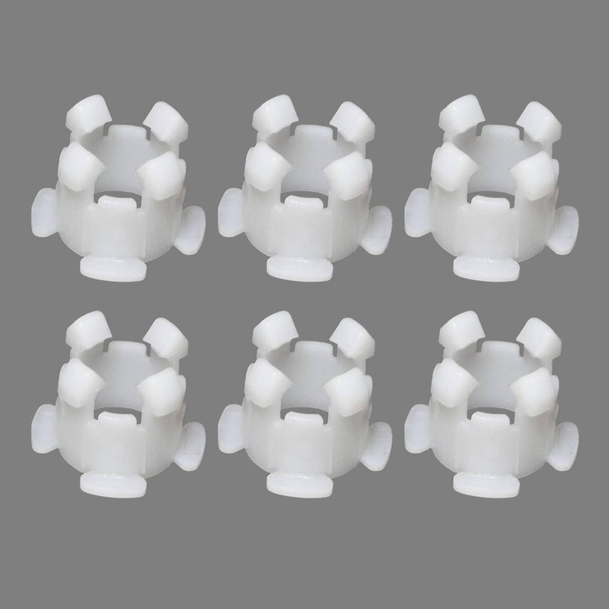 Set of 6 white clutch pedal shaft bushings, multiple views laid out