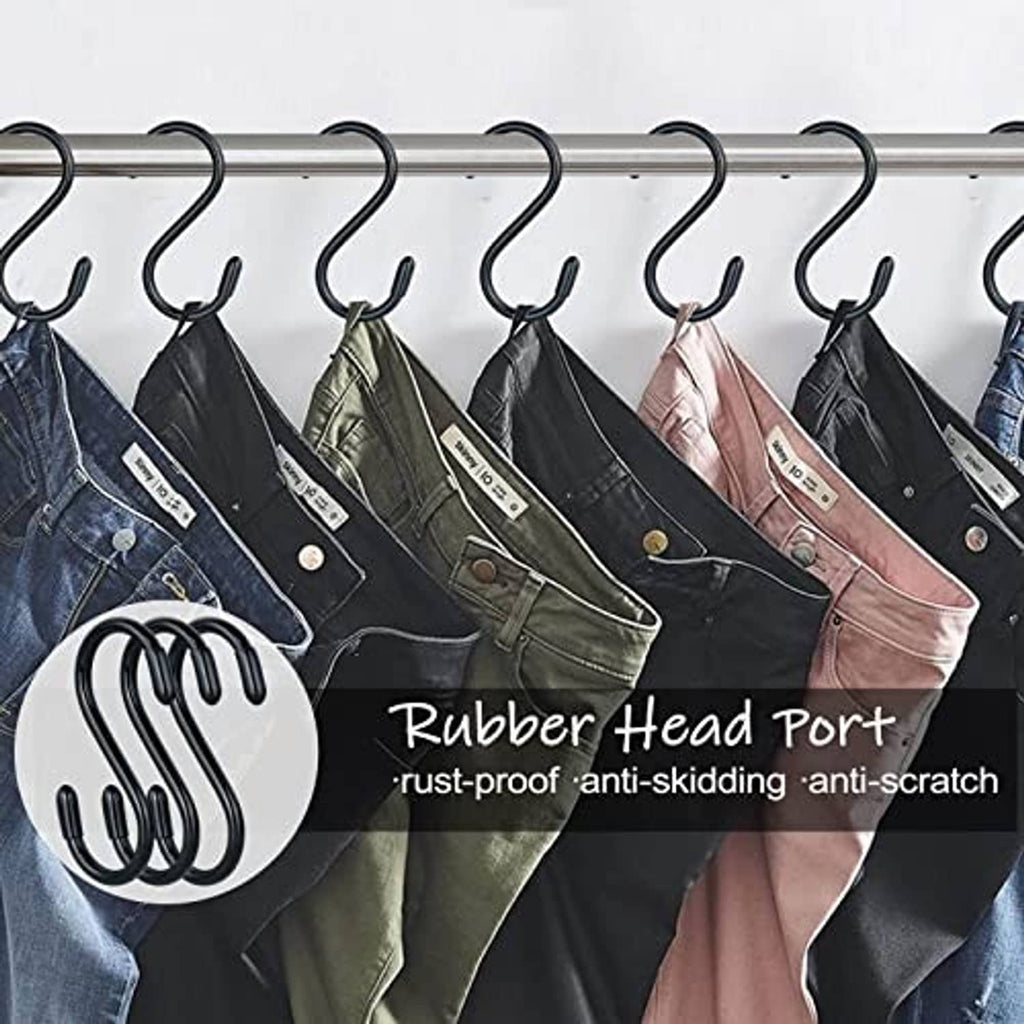 Black S hooks attached to a metal rod, holding shirts and pants on closet rack.