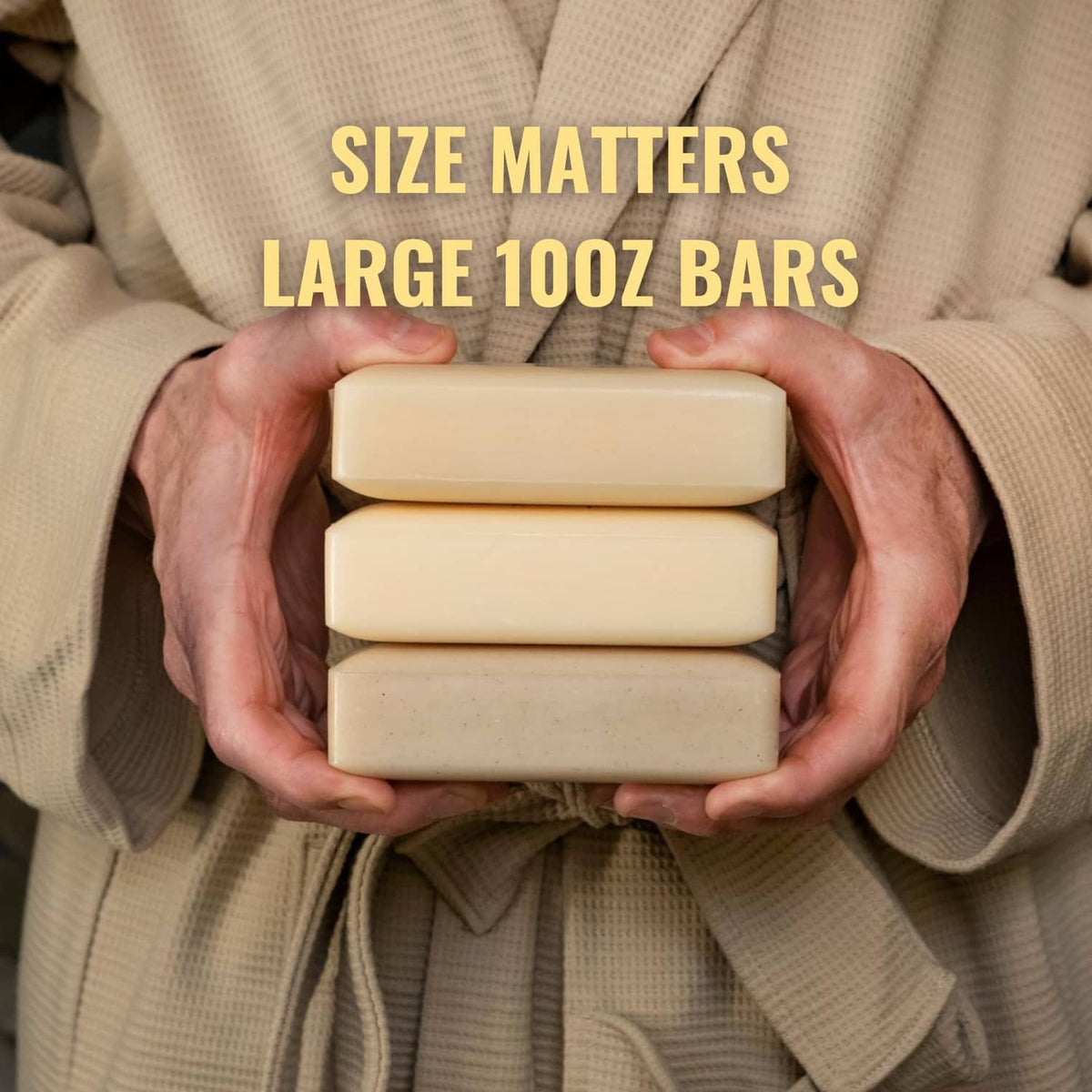 Three stacked beige Man Bar soap bars held in hands