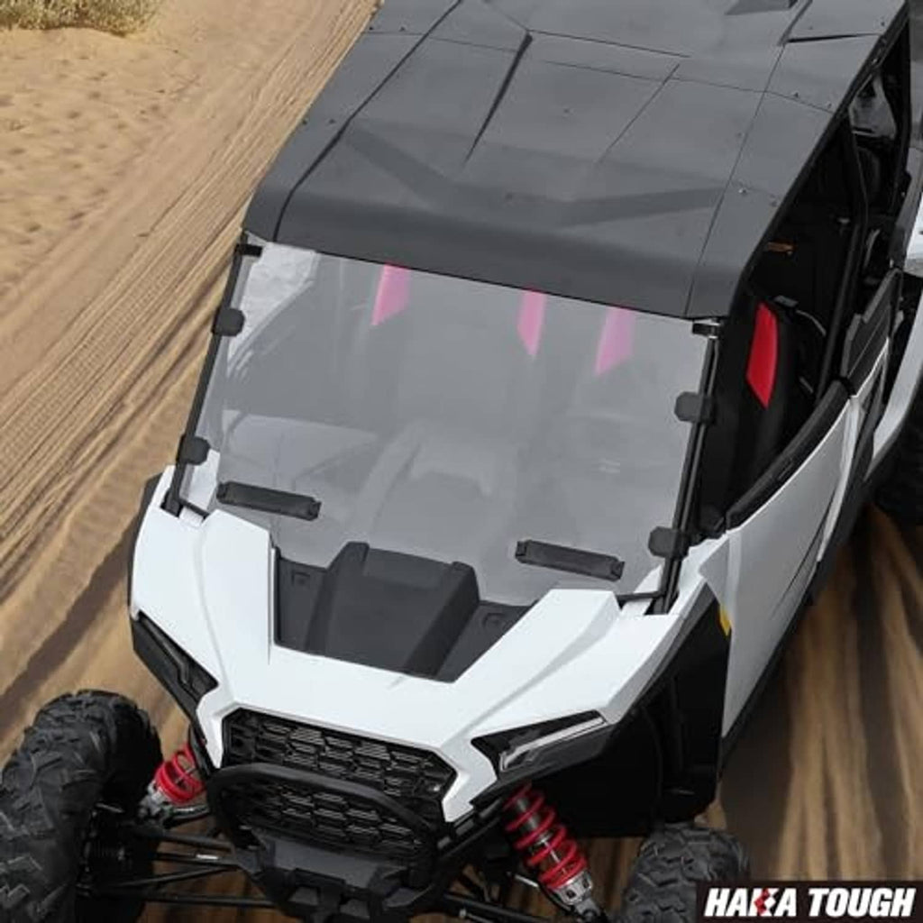 Vented windshield installed on white off-road UTV with black support brackets