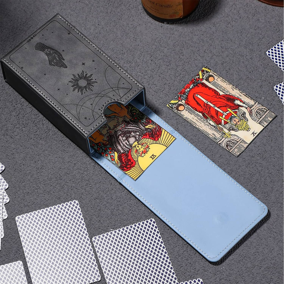 Grey tarot card case with moon and hand print, holds tarot cards in open slot