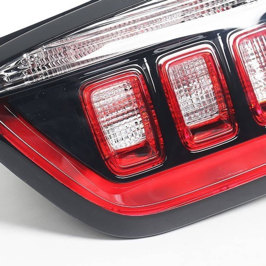 Right inner halogen tail light close-up, three red-and-clear square lenses on black