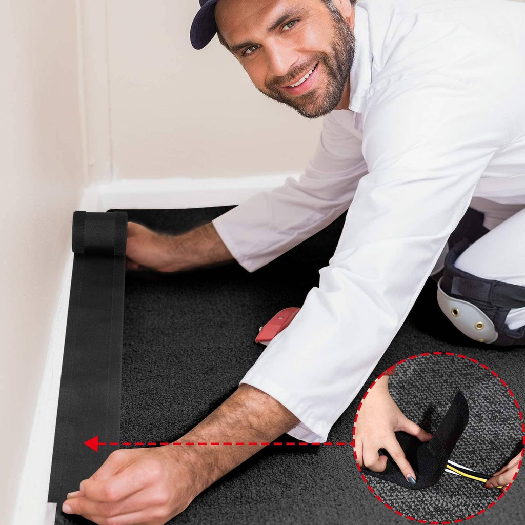 Black cord cover cable protector being installed on carpet over floor cables