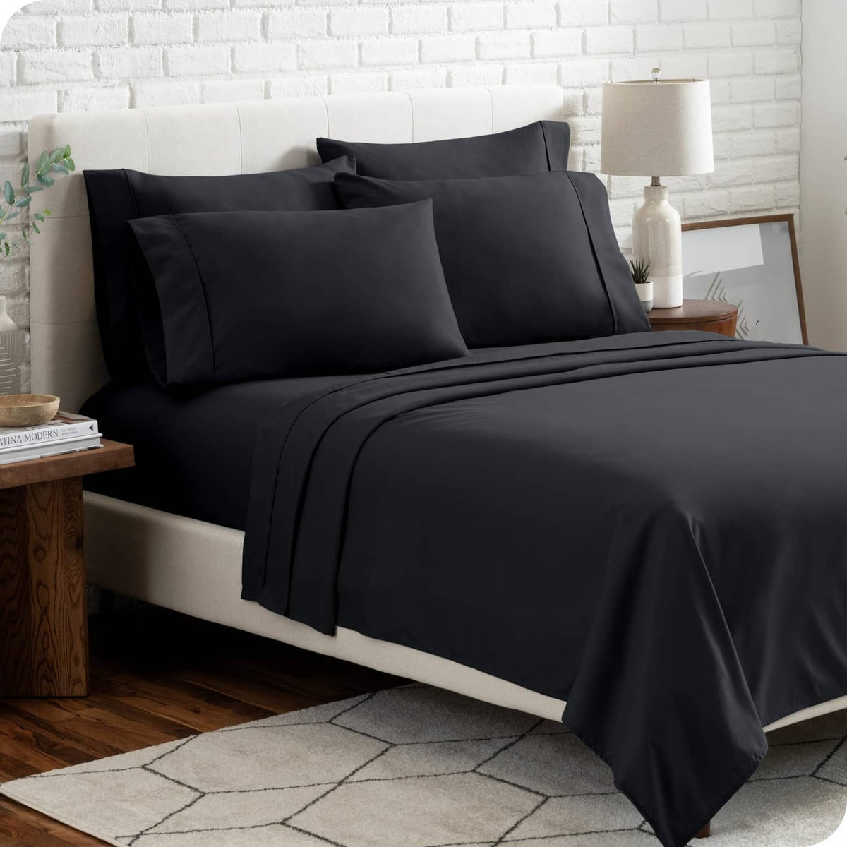 Black bed sheet set on bed with color swatch strip at bottom.