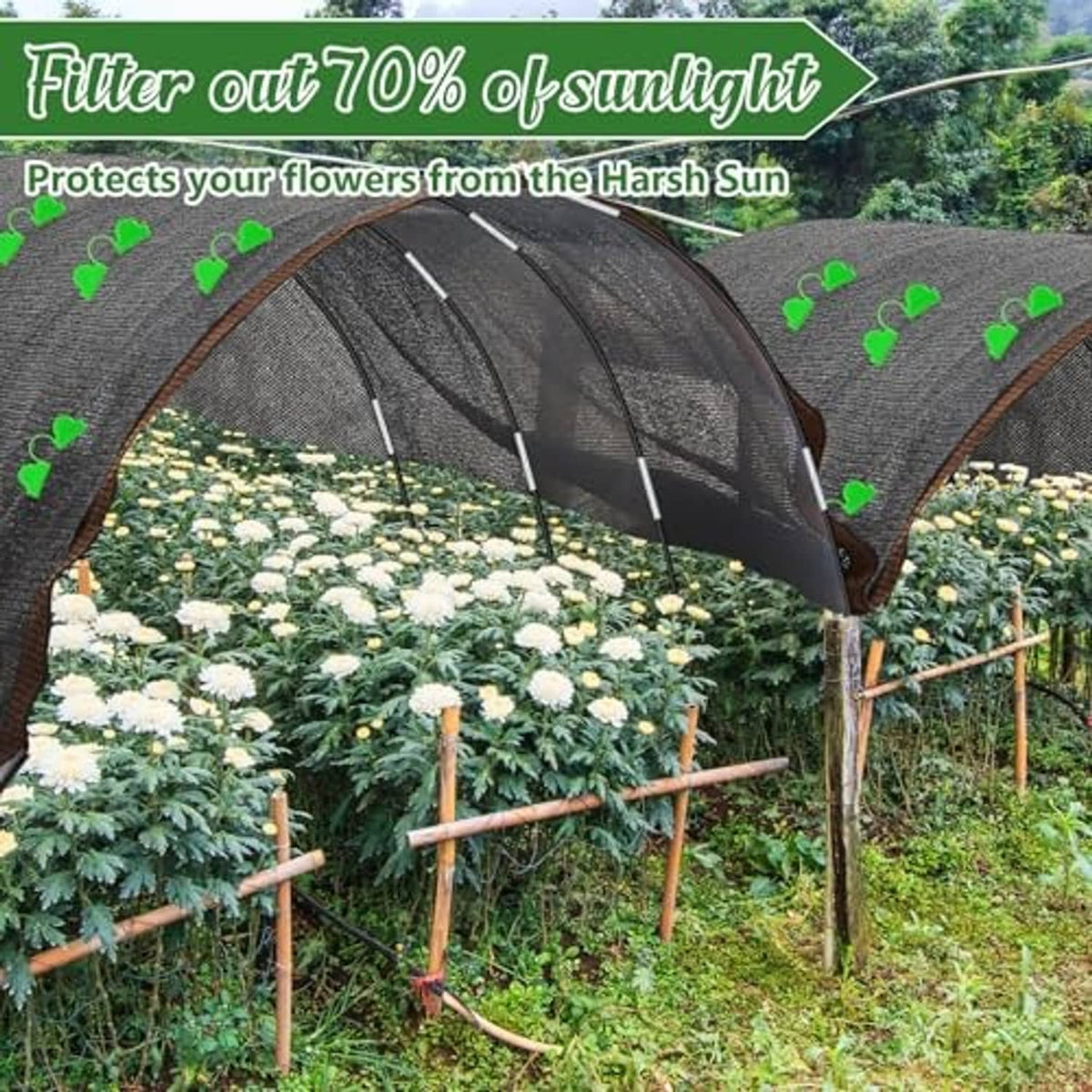 Black shade cloth tunnel over flowering plants with arched hoop supports