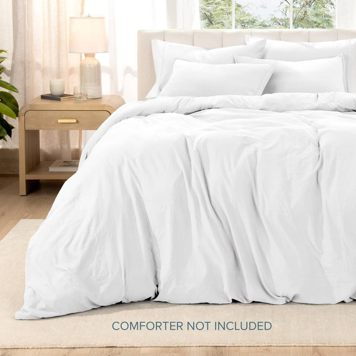 White queen duvet cover set with pillow shams, neatly draped on bed