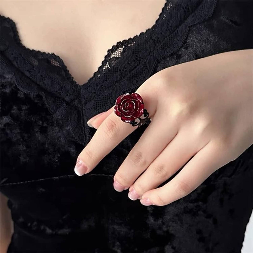 Dark red rose openwork gothic ring with black heart-like scrolls on finger
