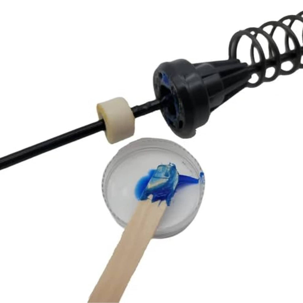 Grease applicator tool with black rod, spring, and small white nozzle pieces
