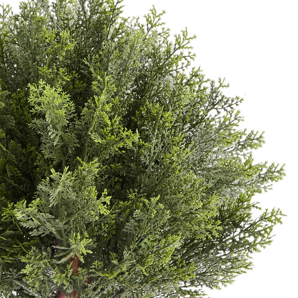 Artificial cypress topiary tree with dense green faux needles, side foliage close-up