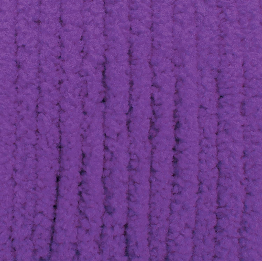 Purple yarn close-up showing thick loops and knit-like ridged texture