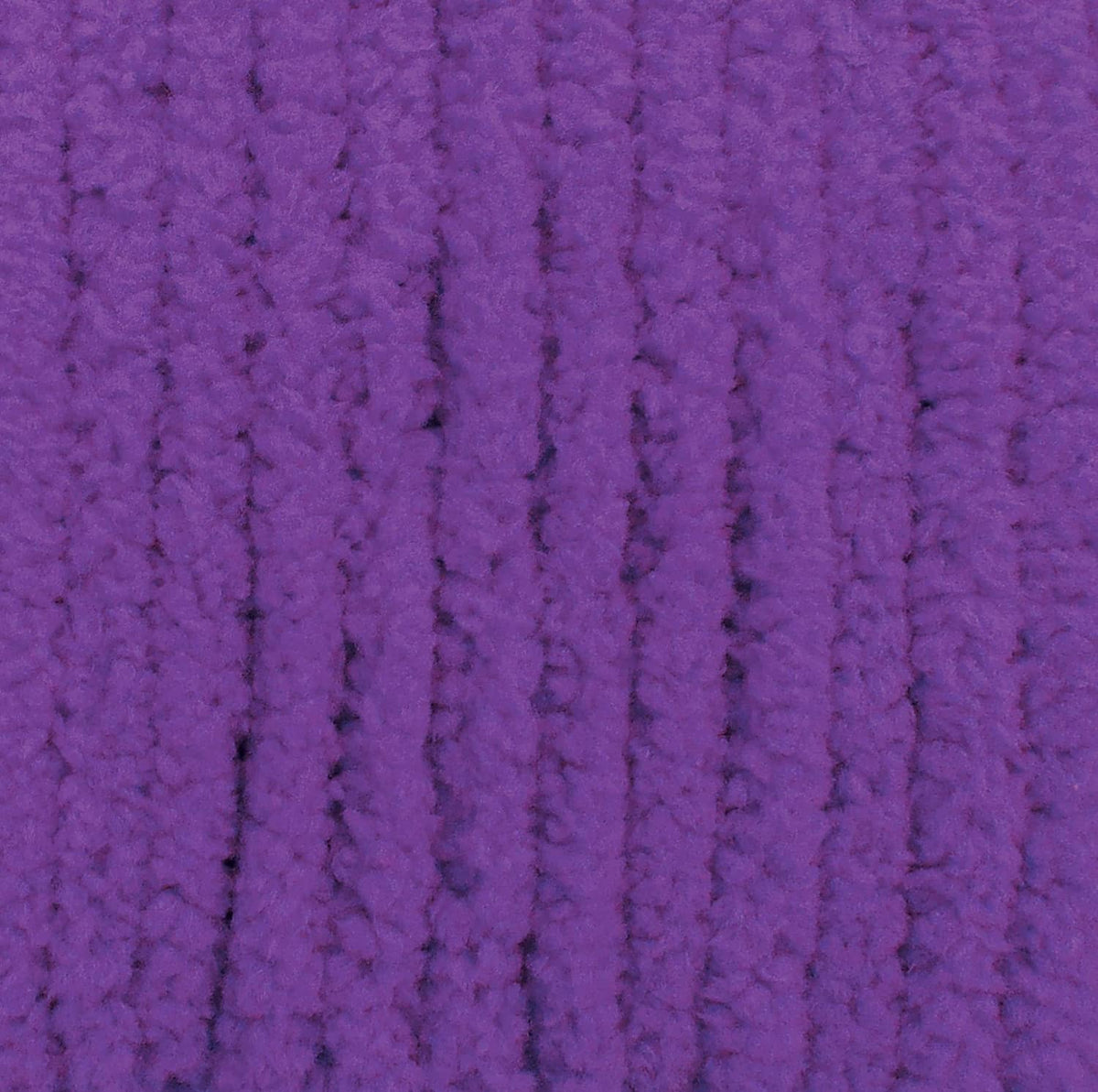 Purple yarn close-up showing thick loops and knit-like ridged texture