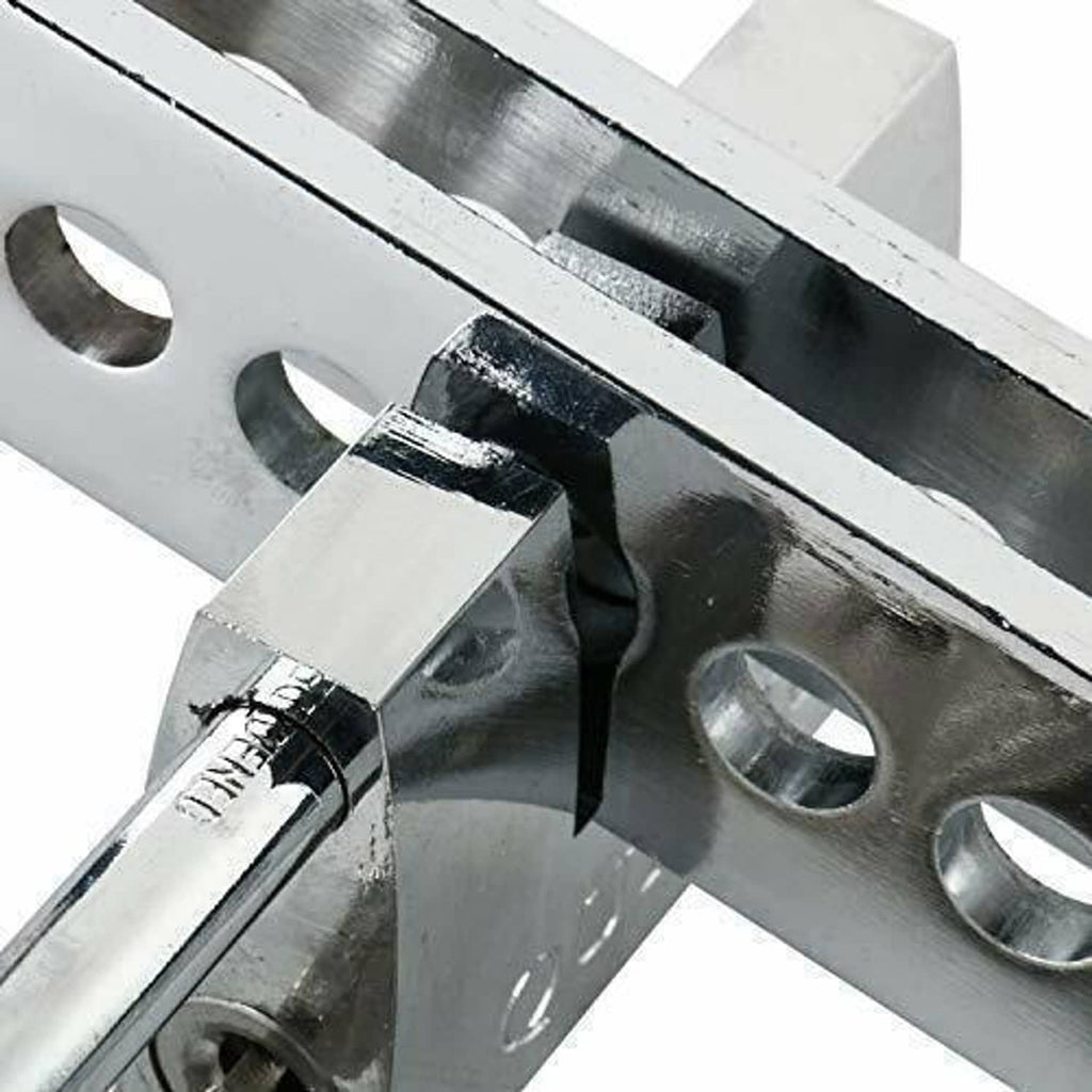 Close-up of steel pedal lock mechanism with crossbar and locking pin