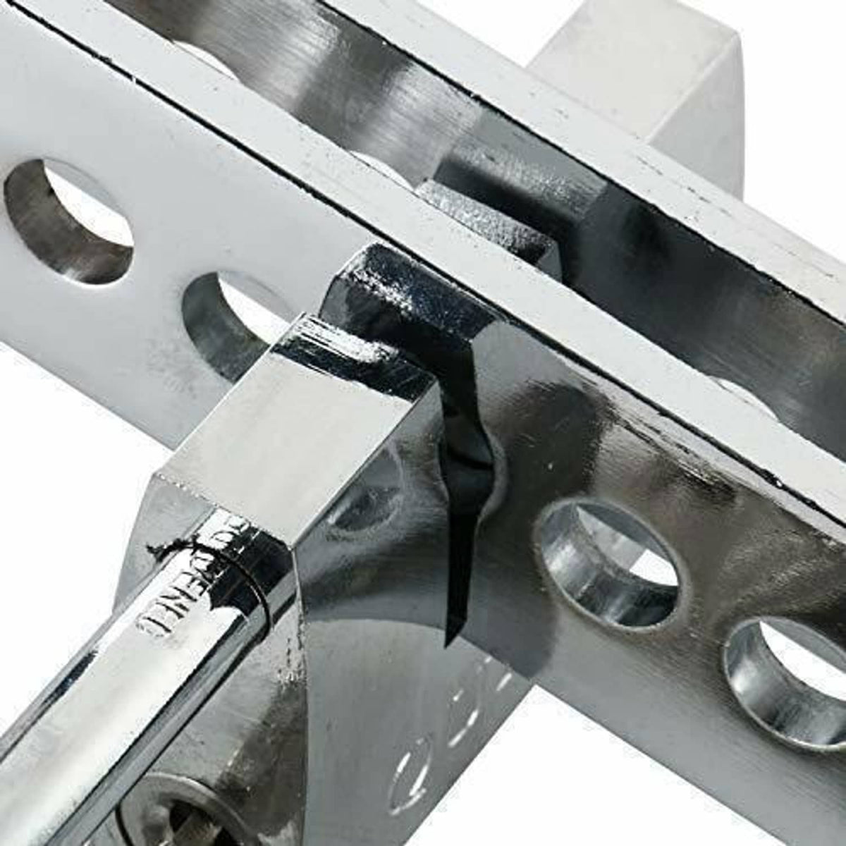 Close-up of steel pedal lock mechanism with crossbar and locking pin