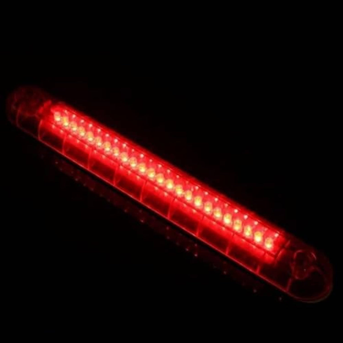Red third brake light bar glowing with LED row through clear lens