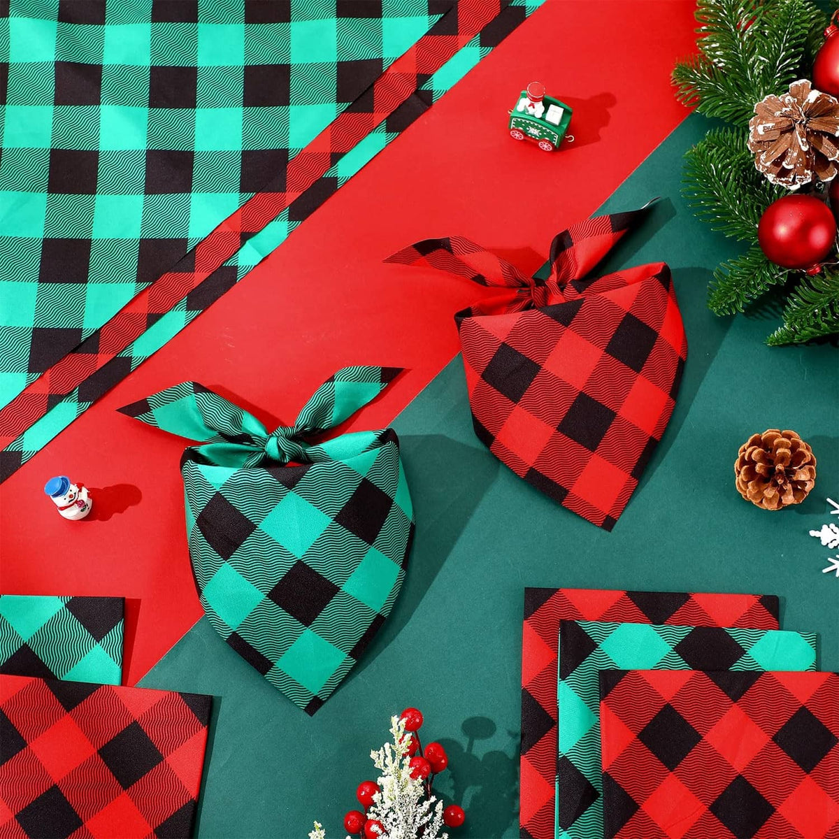 Plaid red-and-green dog bandanas with black diamond pattern, folded and tied