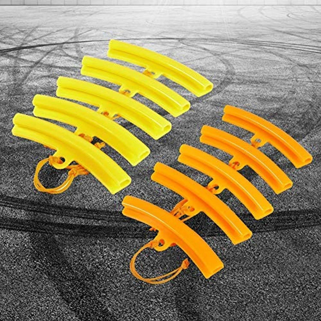 Assorted yellow and orange rim protectors with strap cords laid out on textured surface