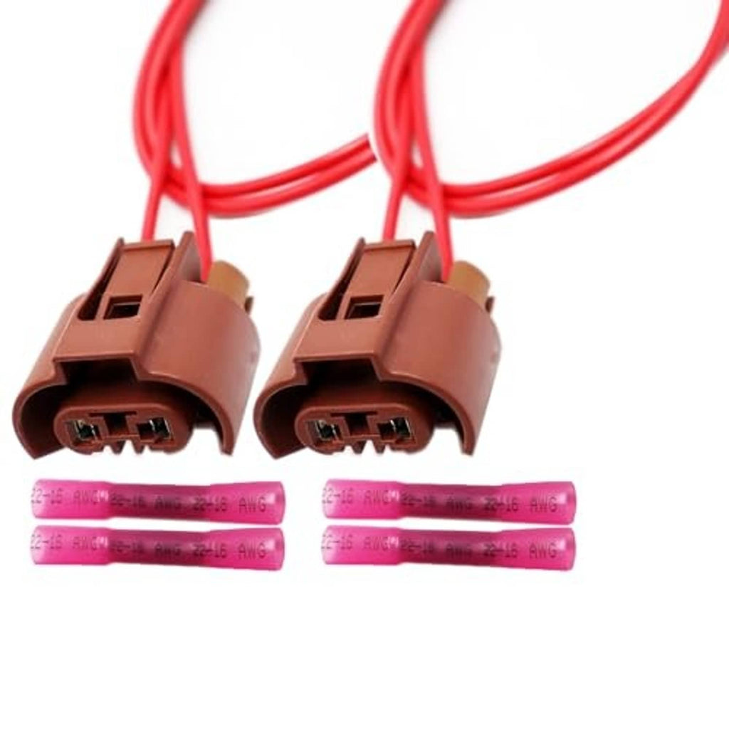 Two brown headlight connectors with red wire leads and purple heat-shrink