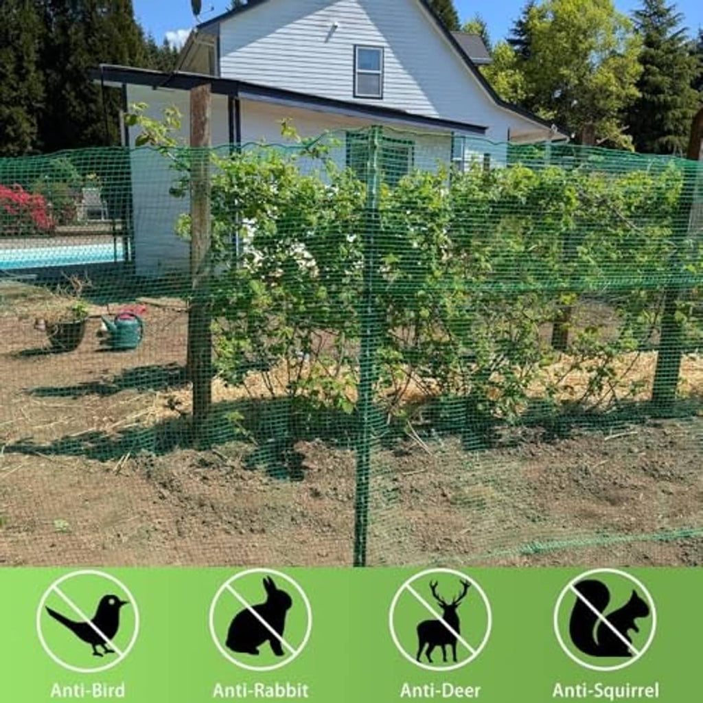 Green plastic mesh fence installed in a garden around plants and posts