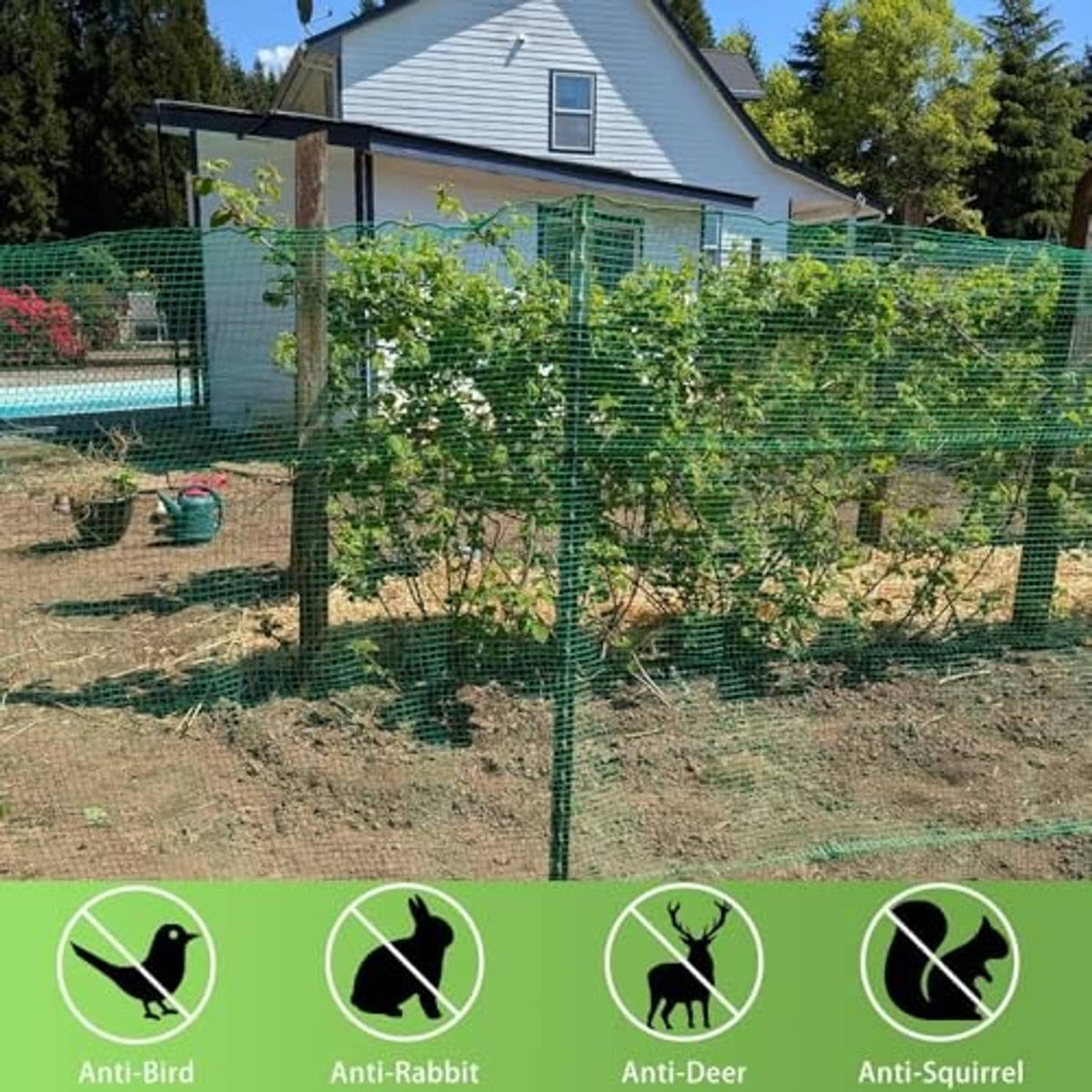 Green plastic mesh fence installed in a garden around plants and posts