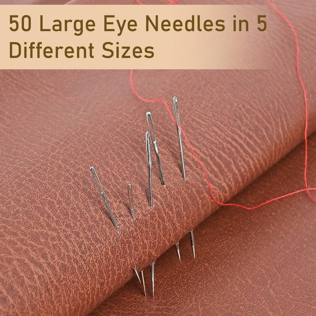 Silvery large-eye sewing needles laid on fabric, mixed lengths for different sizes