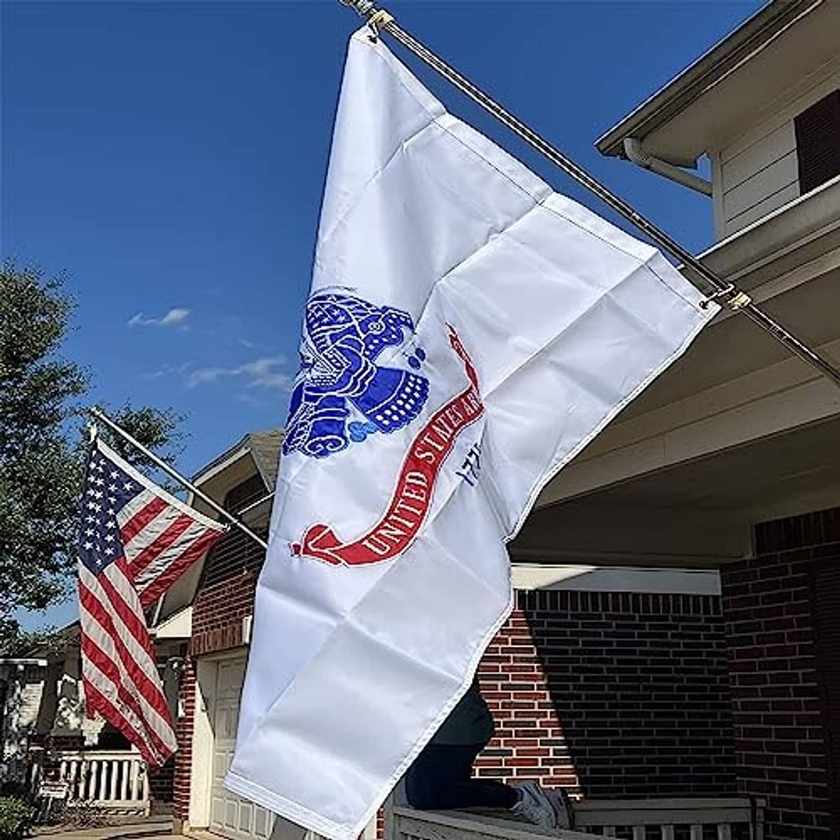 Embroidered US Army flag hanging outdoors from a rooftop pole