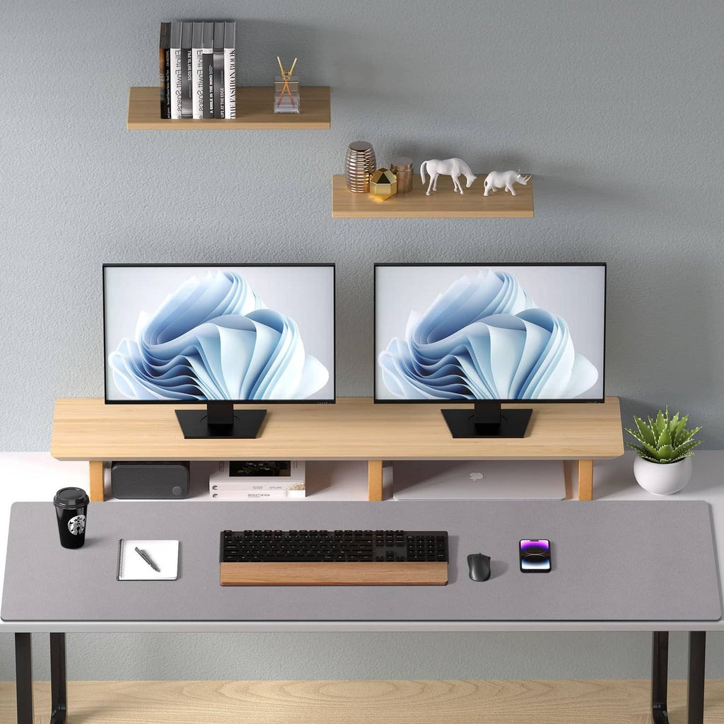 Light grey desk pad protector on modern standing desk with keyboard and phone
