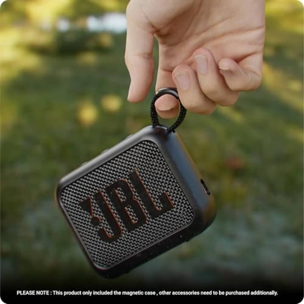 Dark silicone speaker case held by hand with strap loop attached
