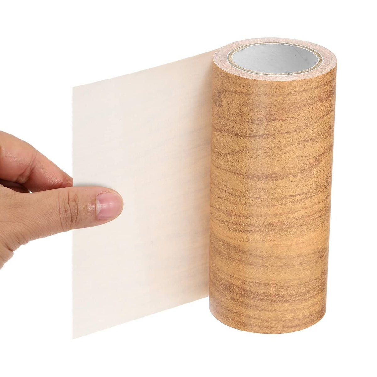 Hand pressing self-adhesive wood-grain tape onto a smooth surface