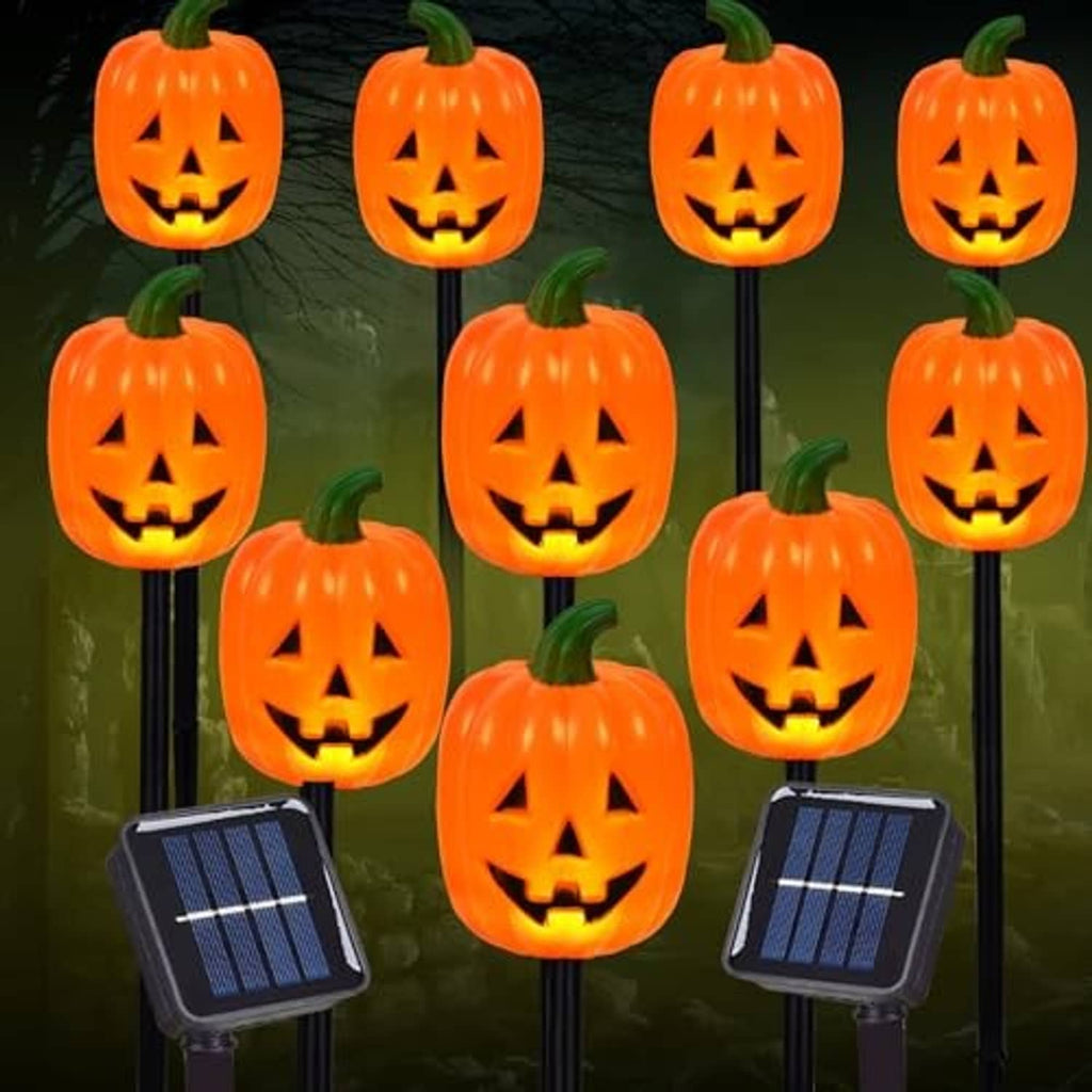 Jack-o'-lantern pumpkin stake lights with solar panels, orange faces on stakes