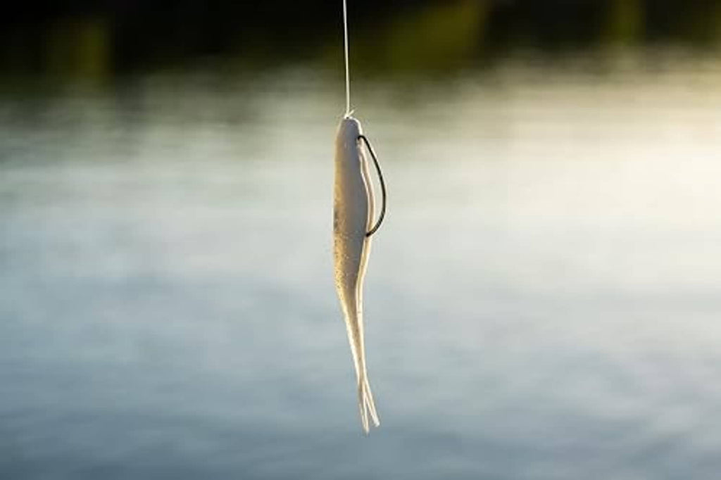 Purple-speckled soft plastic jerk bait hanging from a fishing line