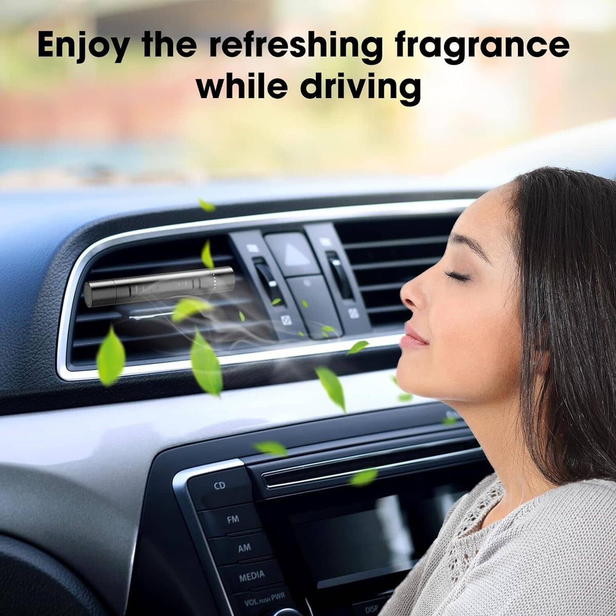 Car vent air freshener diffuser clip releasing fragrance near the dashboard vent