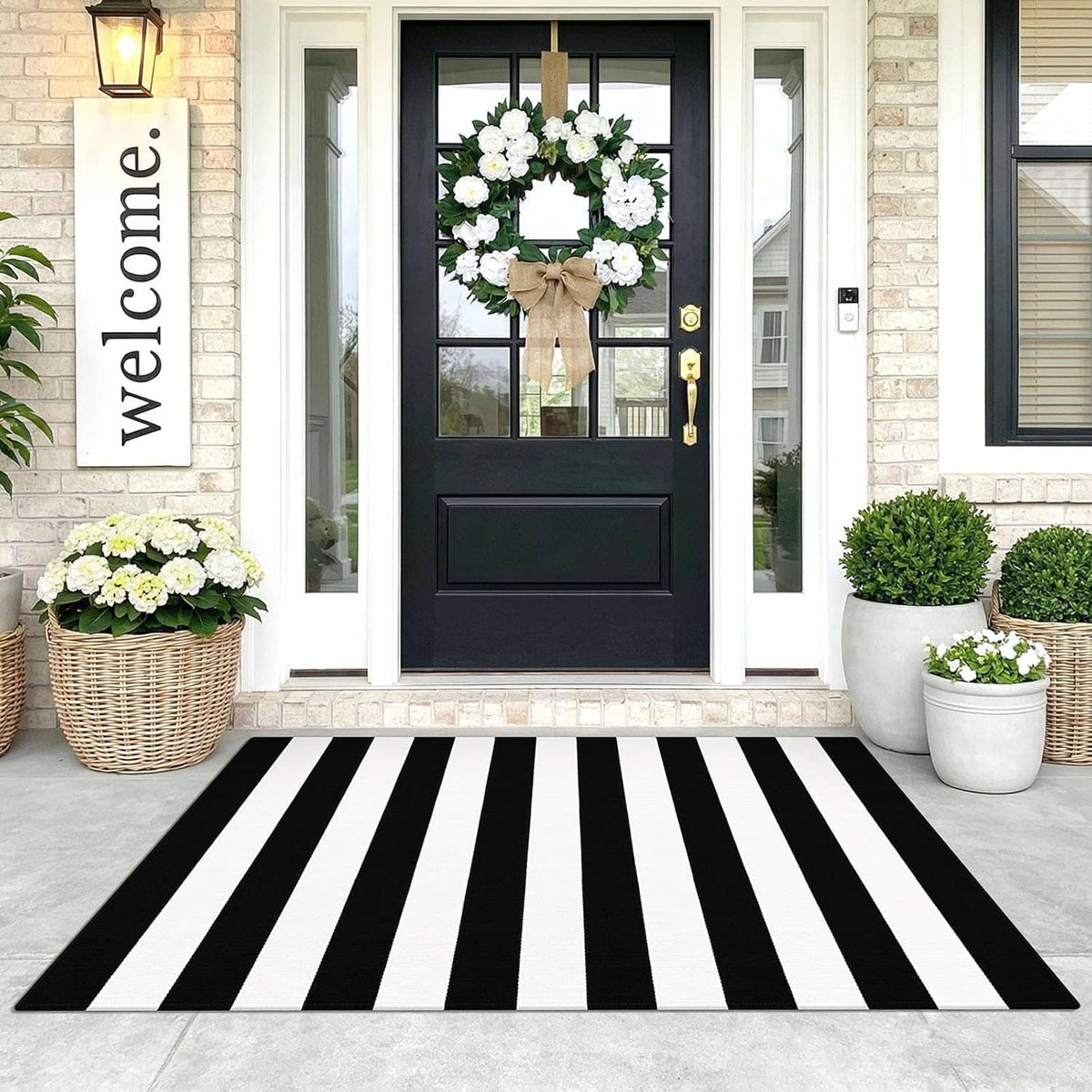 Black and white striped area rug with bold vertical bands, rectangular doorway rug