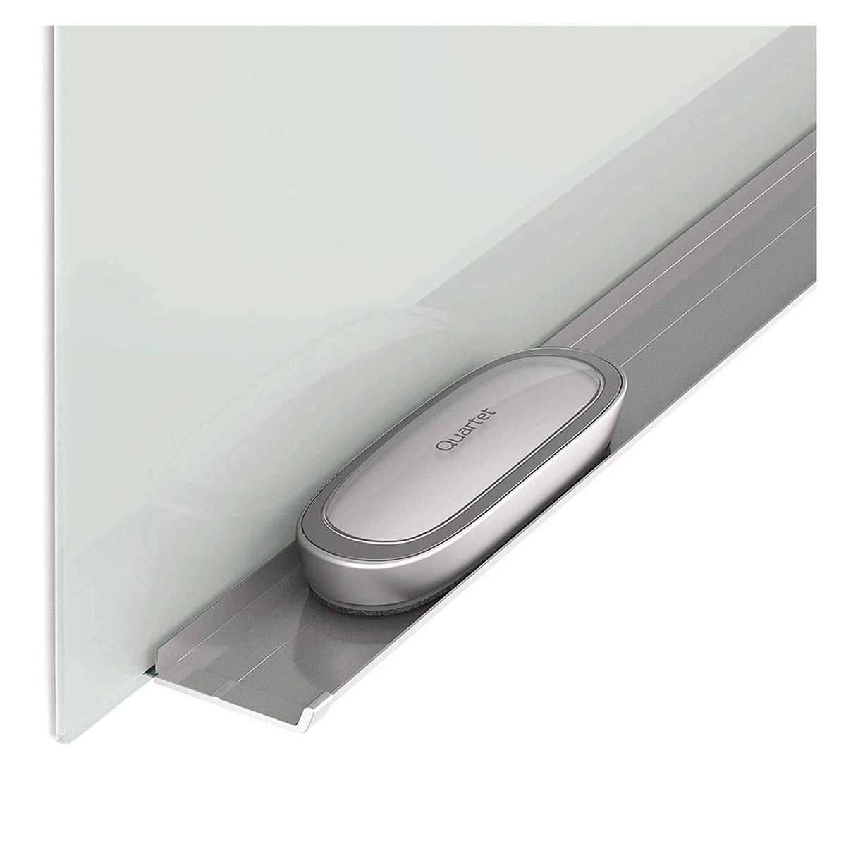 Quartet dry erase eraser resting in a gray caddy along a whiteboard ledge