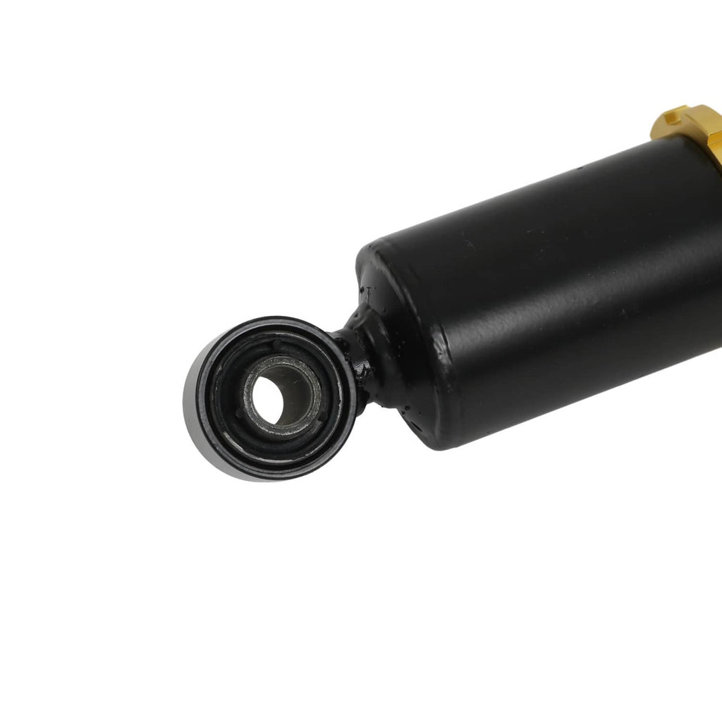 Black shock absorber end with rubber bushing near mounting housing on coilover strut