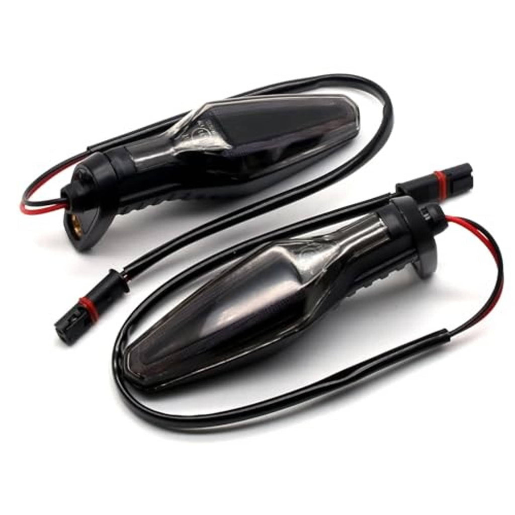 Motorcycle front turn signal lights with smoked lenses, black bodies, and attached leads