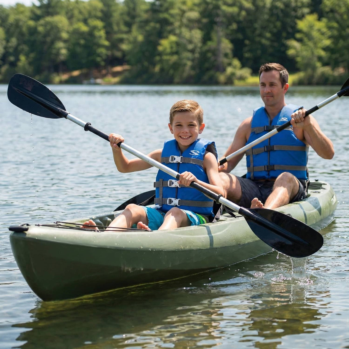 Blue kids life vest with gray harness straps, worn while kayaking