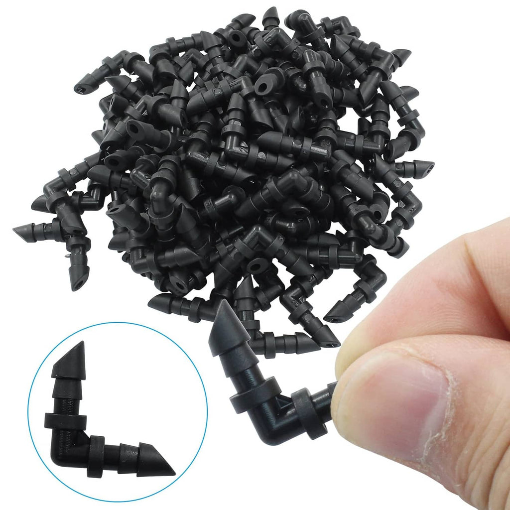 Black barbed drip elbow coupling fittings pile, hand holding one 1/4 in piece