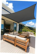 Gray rectangle sun shade sail stretched over patio seating