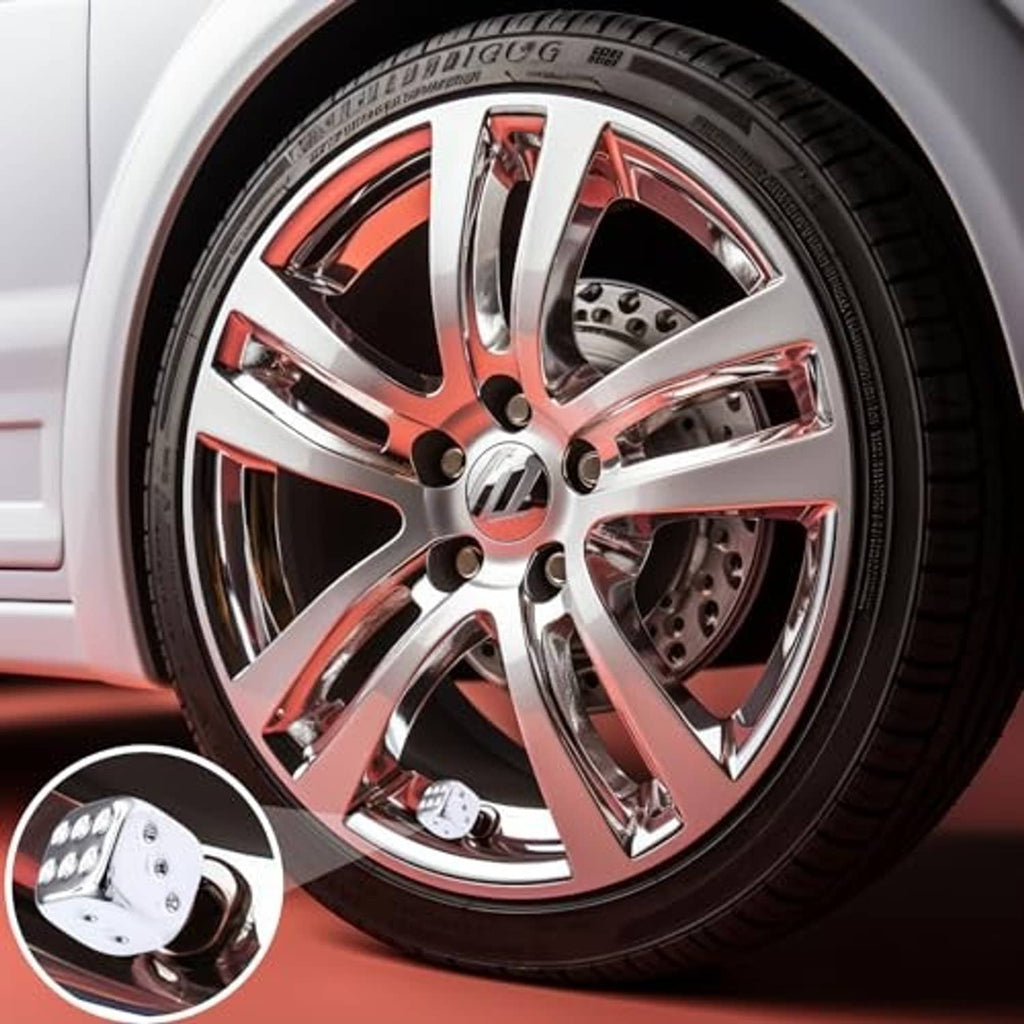 Silver chrome dice valve stem cap on a wheel, close-up with threaded insert
