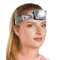 Foxelli LED headlamp on a person’s head with spotted fabric strap and bright front light