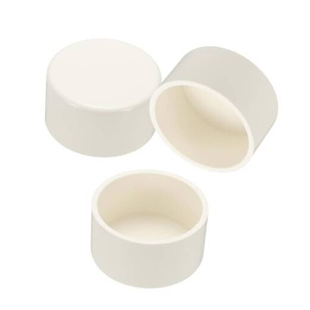 White PVC pipe end cap plugs, 2.5-inch diameter, shown as three caps with openings