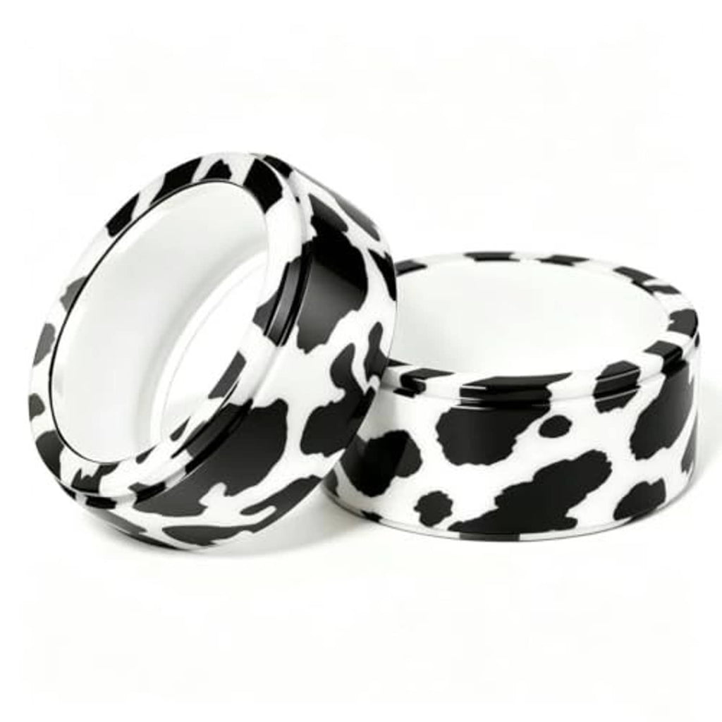 Two cow print smart ring covers with open backing, stacked side view.