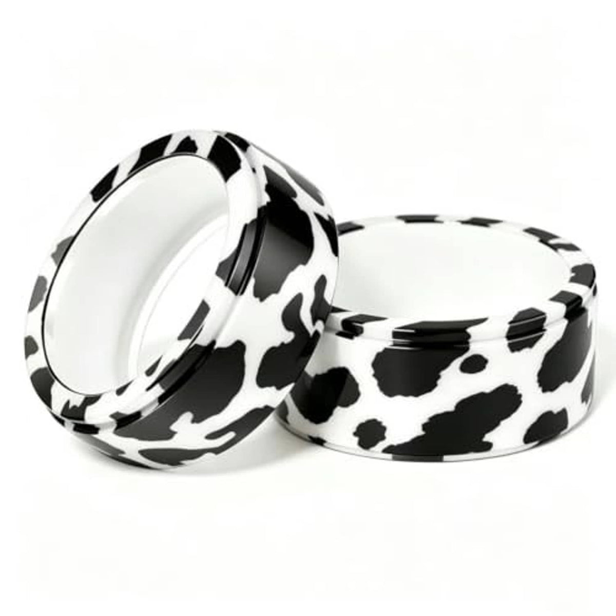 Two cow print smart ring covers with open backing, stacked side view.