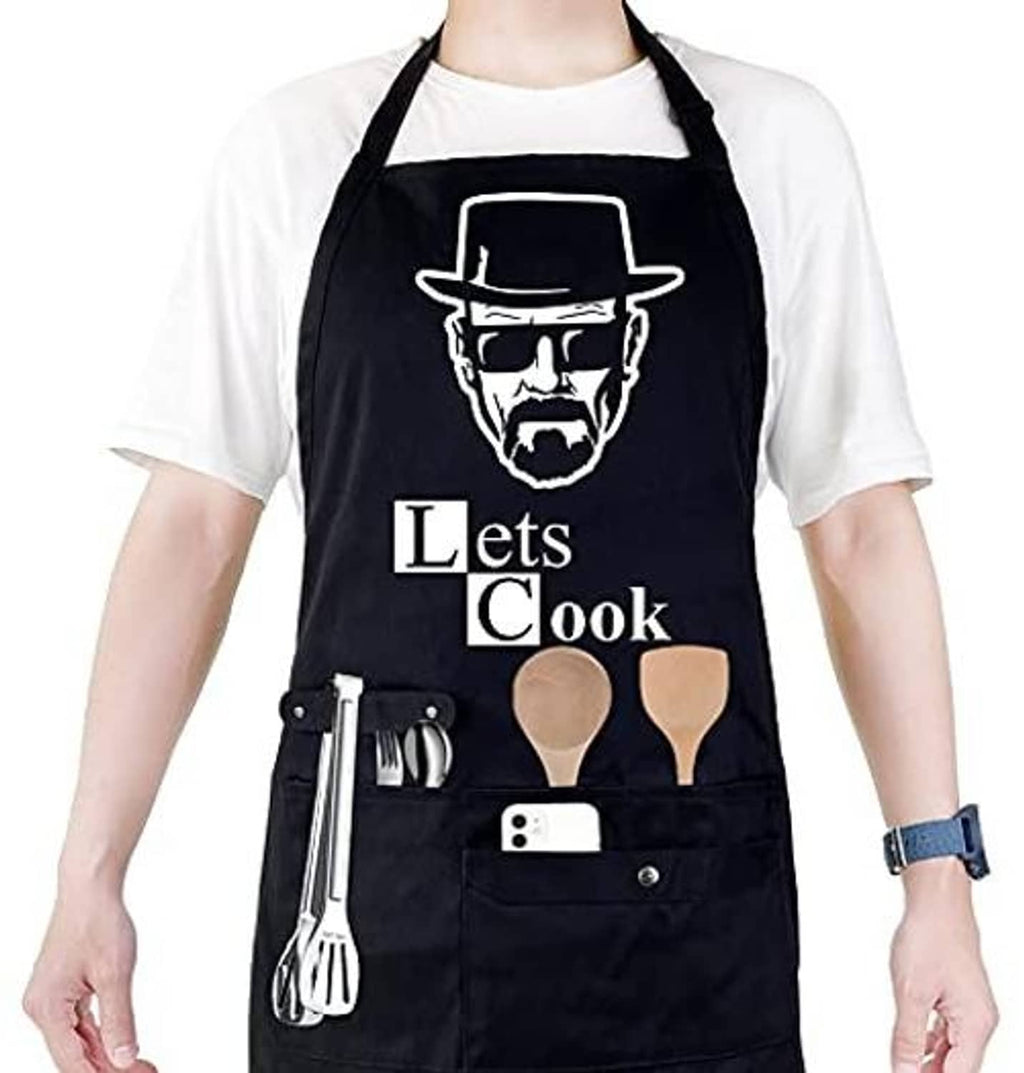 Black chef apron with "Let's Cook" graphic, utensil holder and front pocket