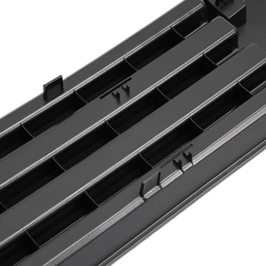 Close-up of black grille insert with horizontal slats and raised mounting points