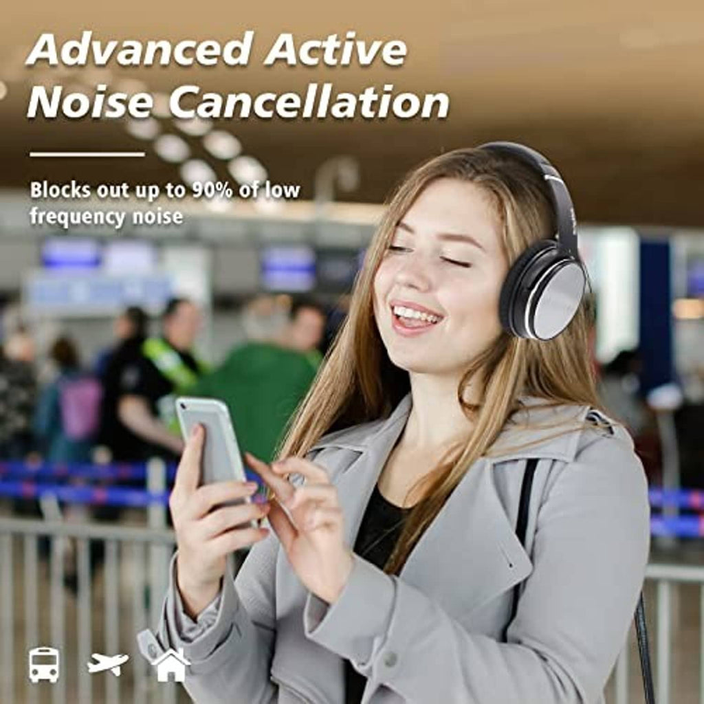 Black over-ear headphones worn by a smiling woman in a jacket