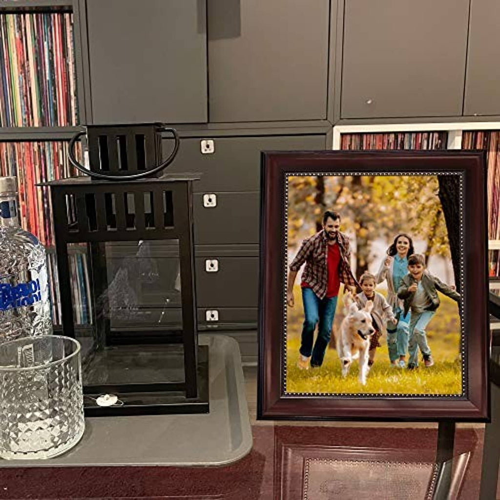 Brown tabletop picture frame displaying a family photo with lit decorative border