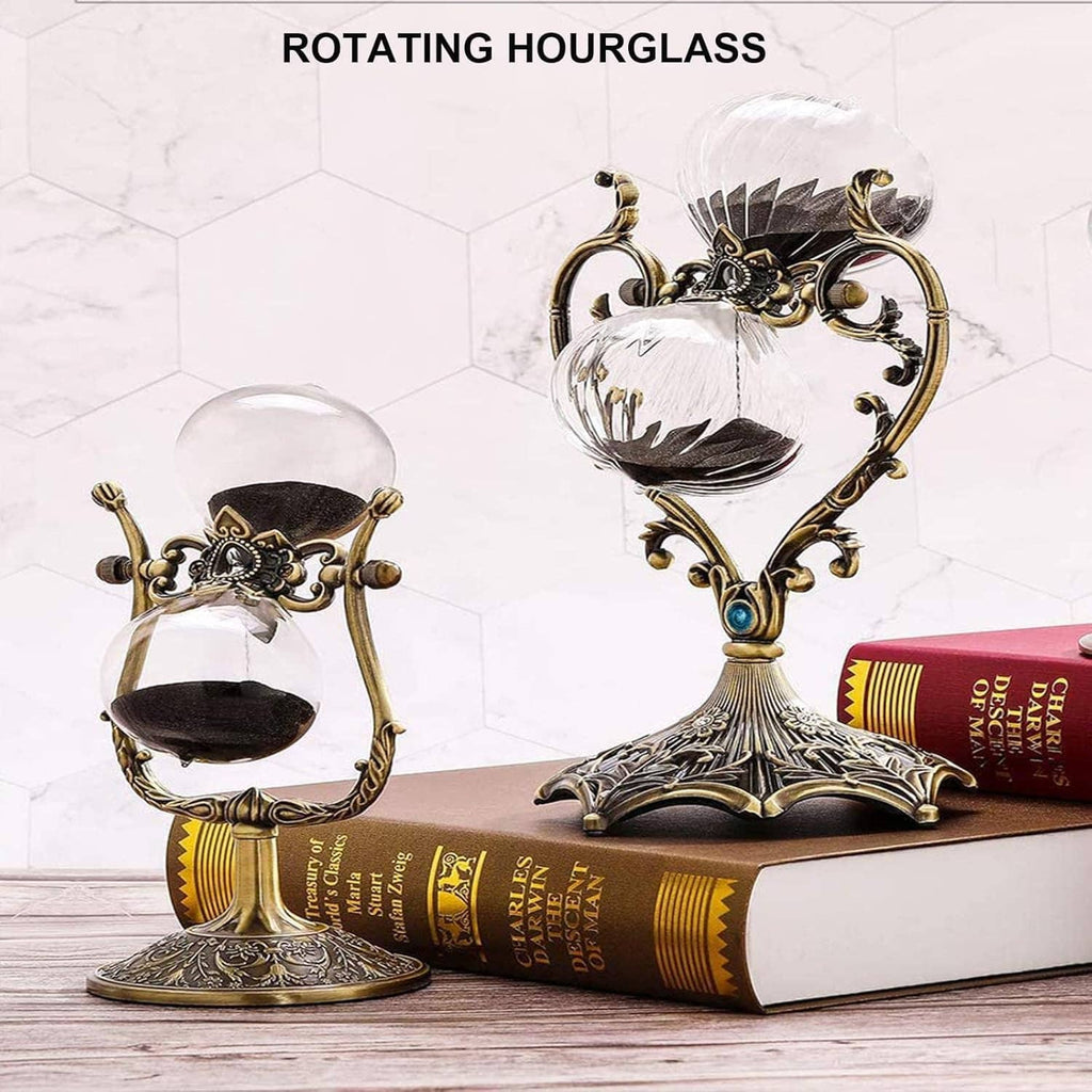 Rotating hourglass timer with clear sand chamber, antique brass stand, and books